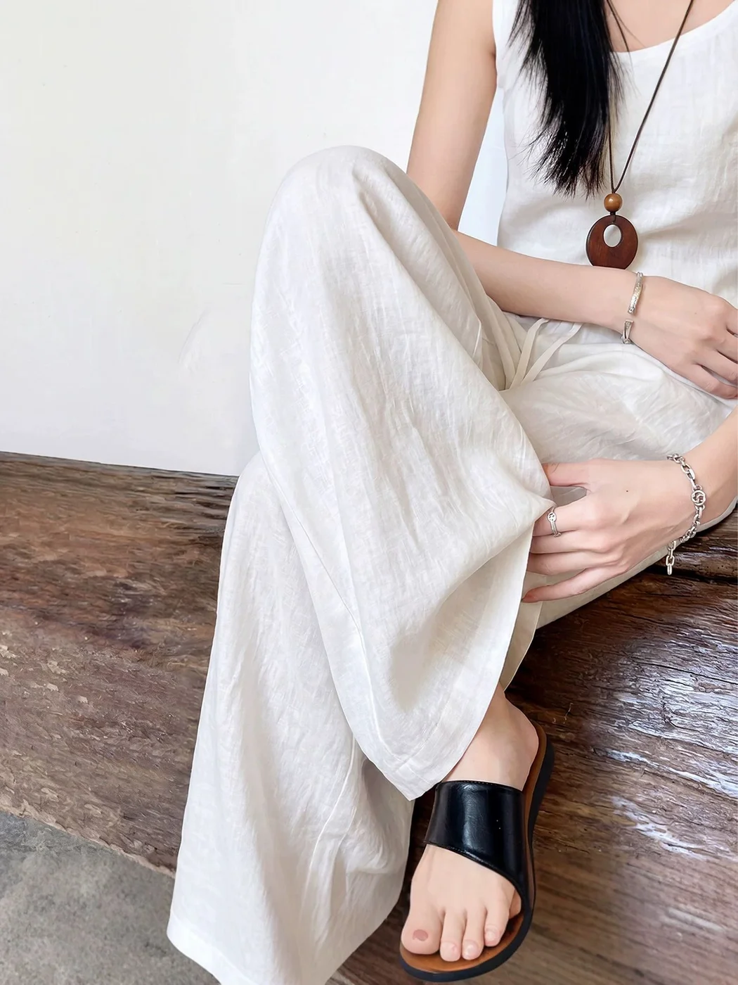 Lyocell-Blend Wide-Leg Trouser — Wide-leg lyocell-blend trousers with a drawstring waist, shown in black, oat white, charcoal and navy