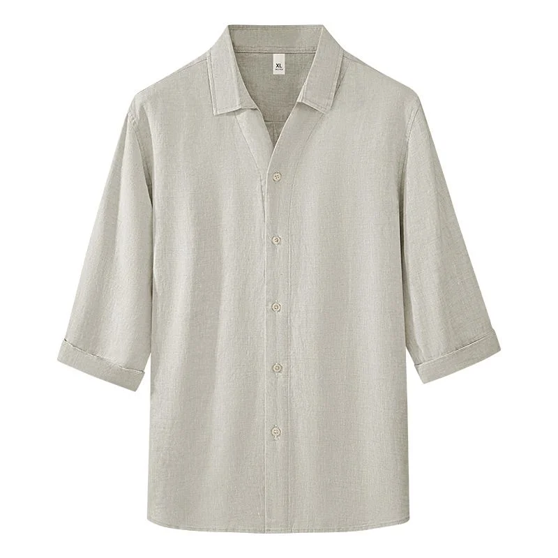 Men’s Linen Shirt — A loose natural-flax linen shirt with a soft collar and three-quarter sleeves, laid flat on white