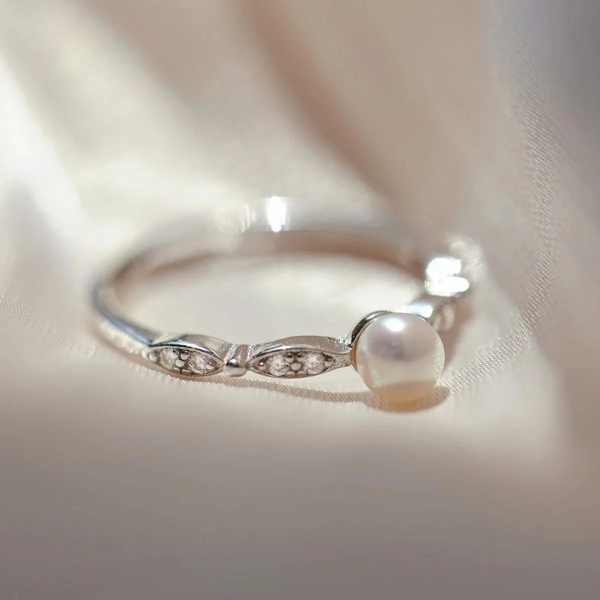 Pearl & Pavé Ring — Slim silver-tone ring with a single freshwater pearl and pavé-set shoulders